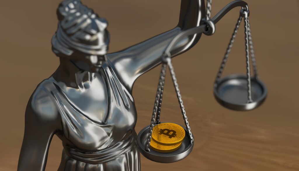 an image of a statue holding a scale with bitcoin on one side.