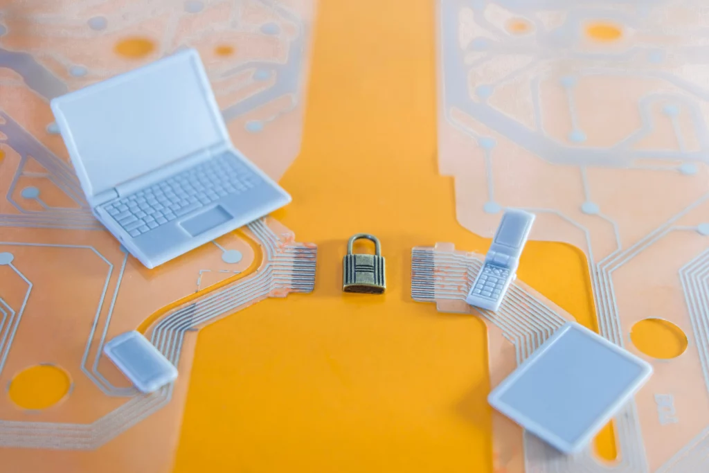 An image of a padlock in the midst of little model tech devices. It depicts communication and information security, which is what zero-knowledge proof aims to provide.