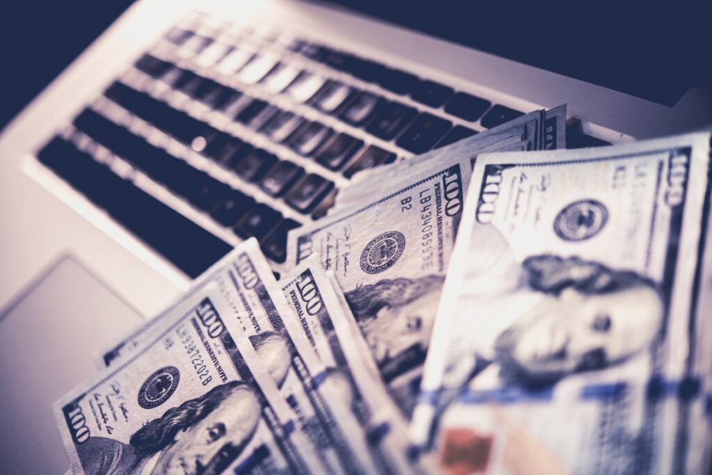 US Dollar bills against a laptop keyboard