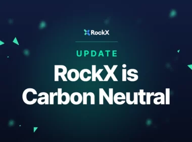 Dark blue background with teal triangles in the foreground and text reading "Update: RockX is Carbon Neutral".